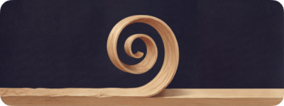 The logo: a curled wood shaving on a workbench