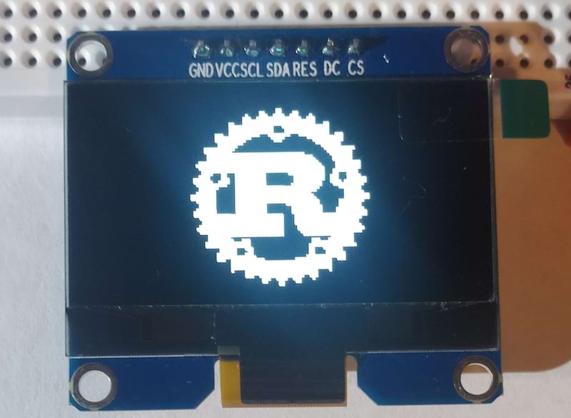 SSD1309 display module showing the Rust logo