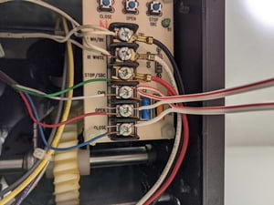 Close-up of wiring to common, open, and close terminals inside opener