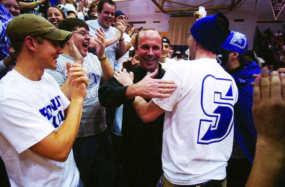 <b>Basketball Game </b><br /> Father Pilarz greets fans at a Royals basketball game.