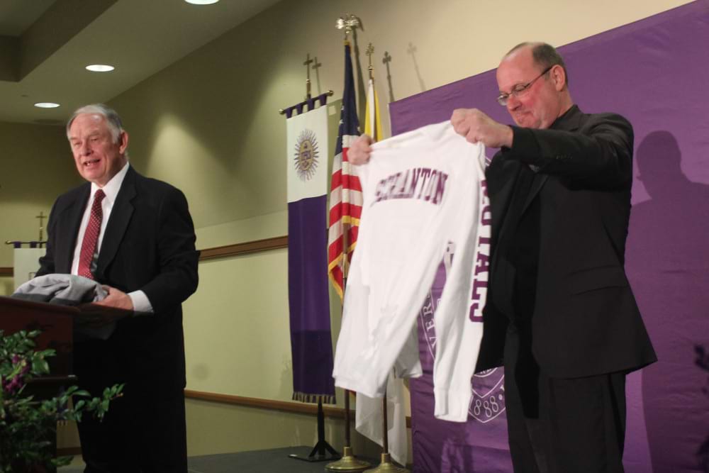 <b>Father Pilarz with t-shirt </b><br /> Rev. Scott Pilarz, S.J., receives a University of Scranton t-shirt during the announcement of his second term as president of the school.