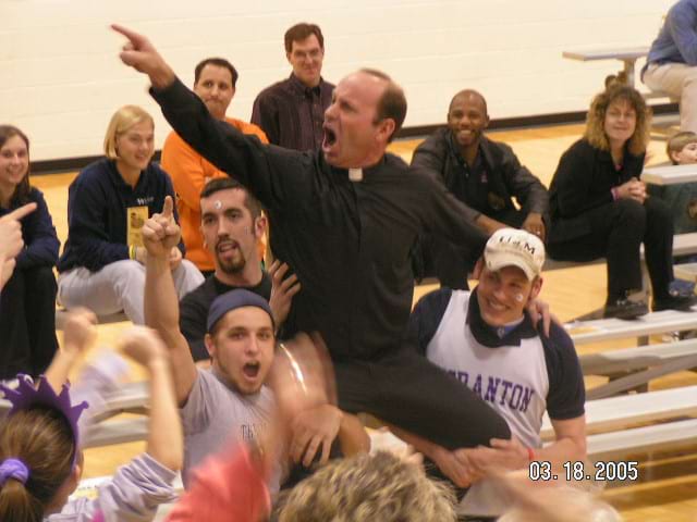 <b>Lady Royals Final Four Trip 2005</b><br /> The late Rev. Scott Pilarz, S.J., former president of The University of Scranton, cheers during a Lady Royals Final Four basketball game in 2005. (Photo courtesy of Drew Clancy '06)