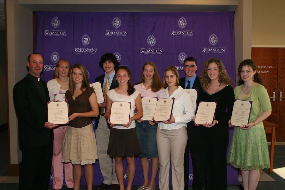 <b>Presidential Scholars 2005</b><br /> Father Pilarz poses for a photo with students who are named Presidential Scholars in 2005.