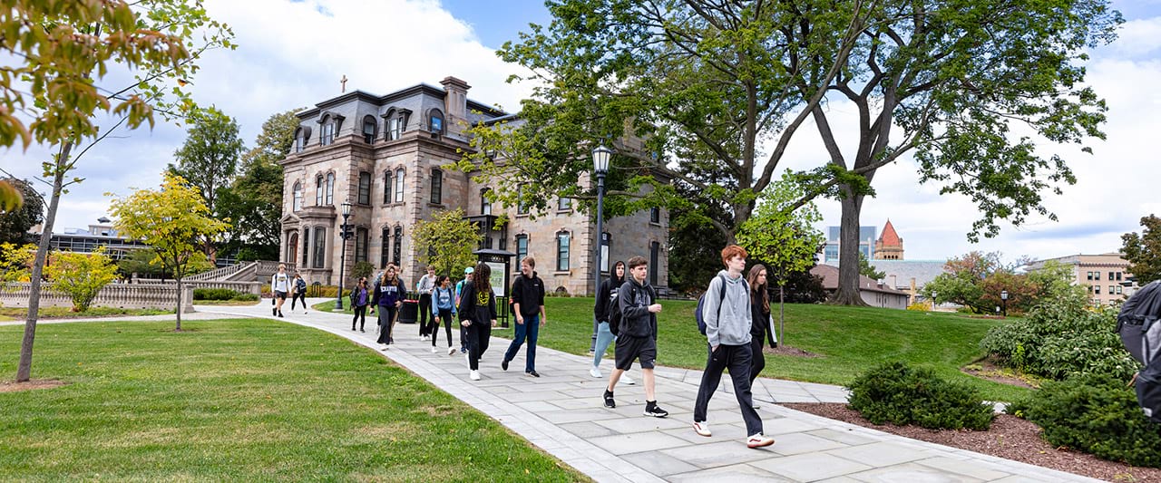  Group of students walking on the pathway in front of The Estate Building.