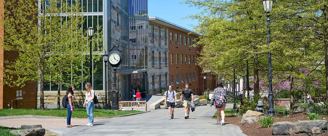  Students on the commons in front of Loyola Science Center on a sunny day.