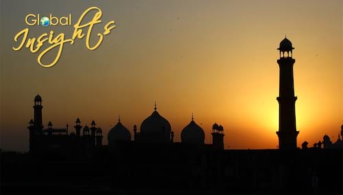 Yellow and orange twilight sky behind the silhouette of  Lahore, Pakistan