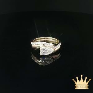 Pear-Shaped Diamond Bypass Engagement Ring and Contoured Diamond Band Set in Yellow Gold