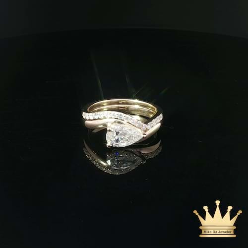 Pear-Shaped Diamond Bypass Engagement Ring and Contoured Diamond Band Set in Yellow Gold
