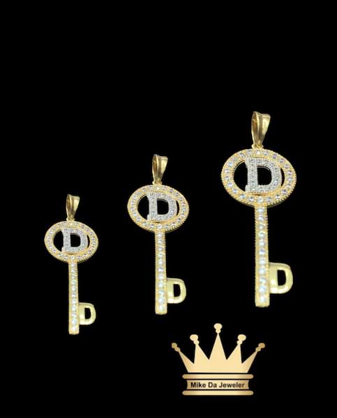 18 k key pendant with initials and cubic zirconia stone on it  weight 1.55 gram size 1.25 inches